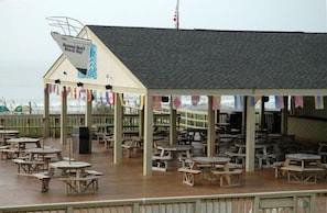 A beachside restaurant with outdoor seating and a covered area. - Weeks in September still available! Book now for a great vacation. (Myrtle Beach)