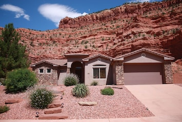 House backs up to stunning cliffs, and faces more red mountains across canyon.