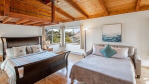 A bedroom with two beds, wooden beams on the ceiling, large windows, and a painting on the wall. - Stunning Oceanview Coastal Home – Beach, Trails, Family Activities (Montara)