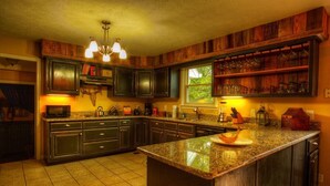 A kitchen with dark wood cabinets, a granite countertop, and a built-in wine rack. - Hendersonville Ranch Getaway that is just 30 minutes from Music City (Hendersonville)