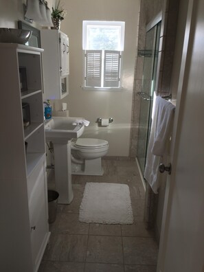 A compact bathroom with a toilet, sink, and shower. - Escape to Tranquility: Your Private Oasis Awaits (Carmel)