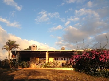 Front view of left half, stepless entry to porch is near the palm tree on left