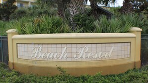 A sign for Beach Resort with a tiled design and a curved top. - Beautiful Beach View Condo!  1 Bedroom, Bunk room and 2 bath (Miramar Beach)