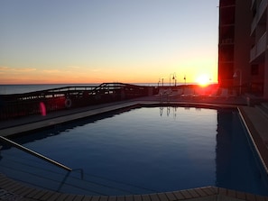 Relax by the serene pool surrounded by a deck and lounge chairs.