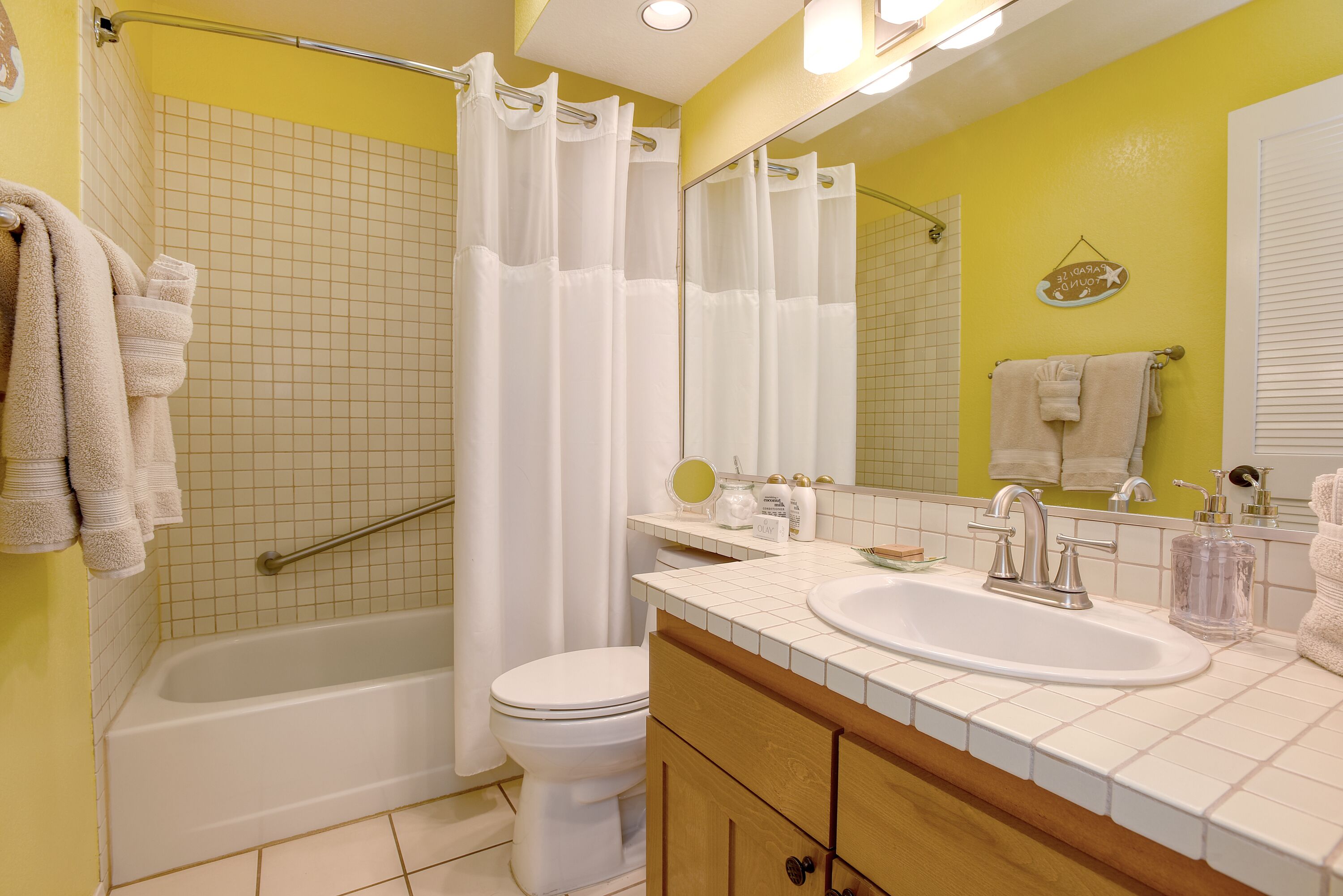 A bathroom with a bathtub, toilet, and sink.