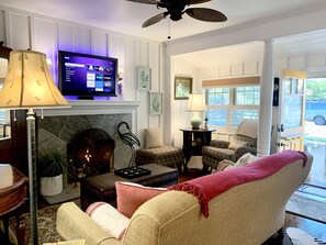 Smart TV, fireplace, books, computer monitors