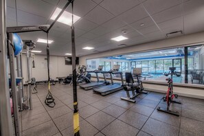 A gym with treadmills, elliptical machines, and a rowing machine. - Ski in ski out Breckenridge Lodging Opulent 3 BDR Chateau  (Breckenridge)