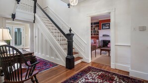A staircase with white railings and a black balustrade, leading to a second floor. - Private Paradise -  Historic 1870 Home on 630 Acre Estate - Pool, Lake, Views (Goochland)