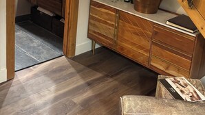 A kitchen with a wooden staircase, a stone sink, and a cabinet with bottles and glasses. -  PARK CITY CANYONS VILLAGE - LUXURY CONDO. ONE OF THE BEST LOCATIONS POSSIBLE, (Park City)