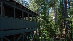 A wooden covered bridge in a forested area.
