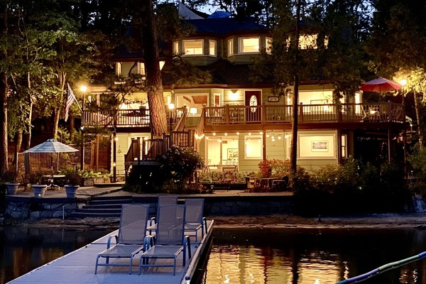 Night time view of the house from the lake in the summer.