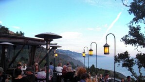 An outdoor restaurant with patrons dining, overlooking a scenic view. - Carmel’s HIGHEST RATED and Most ROMANTIC Getaway - Walk to Beach and Town (Carmel)