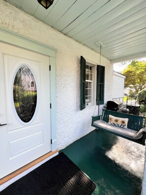 A porch with a white door, green shutters, a bench with a floral cushion, and a grill. - The Inn 1 min walk to Entire Colonial 3BR House Fast WiFi  (Washington)