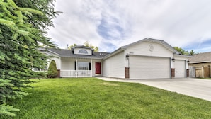 A single-story house with a garage, a red door, and a well-maintained lawn. - Single level 4 bdrm w/2 car garage, Golf Course only 200 yrds away!!! (Meridian)