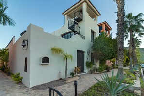 A two-story building with a spiral staircase, a mailbox, and a door. - Loreto Bay Poolside Living, Steps from the Beach and Restaurants (Loreto)