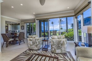 Relax in this spacious living area with a large dining table and comfortable seating for two.