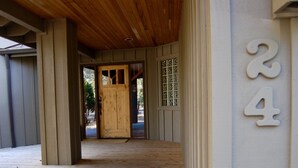 A wooden porch with a wooden door and a number '24' on the wall. - Beautiful 4 Bedroom Renovated Home with A/C; 10 SHARC Passes (Sunriver)