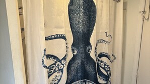 A bathroom with a shower curtain featuring an octopus design. - 2 Bedroom / 2 Bath - Close to Everything! (Myrtle Beach)