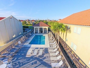 A pool area with lounge chairs and a small building with a red roof. - Resort Home, 6 Bedrms,4.5bath, pool,Pet friendly, on Gulf,Gated (Panama City Beach)