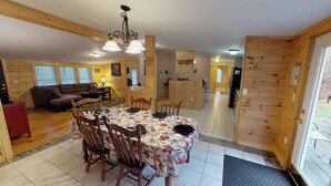 A cozy cabin interior with a dining area, a living room, and a kitchen. - Spacious Bobcat Cabin, 30 mins from Hocking Hills (Nelsonville)