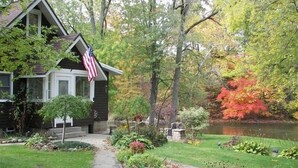 A house with a small garden and a pond. - The River House of Alaska, Michigan located Southeast Grand Rapids, pet friendly (Alto)