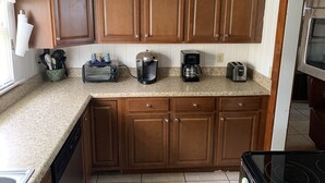 A kitchen with wooden cabinets, a toaster, a coffee maker, and a toaster. - Lake front on North shore of Lake Weir, Florida (it is NOT a duplex / 2 entries) (Ocklawaha)