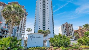 A tall, modern hotel with a sign reading "The Colonades" at 527 East Beach Boulevard.