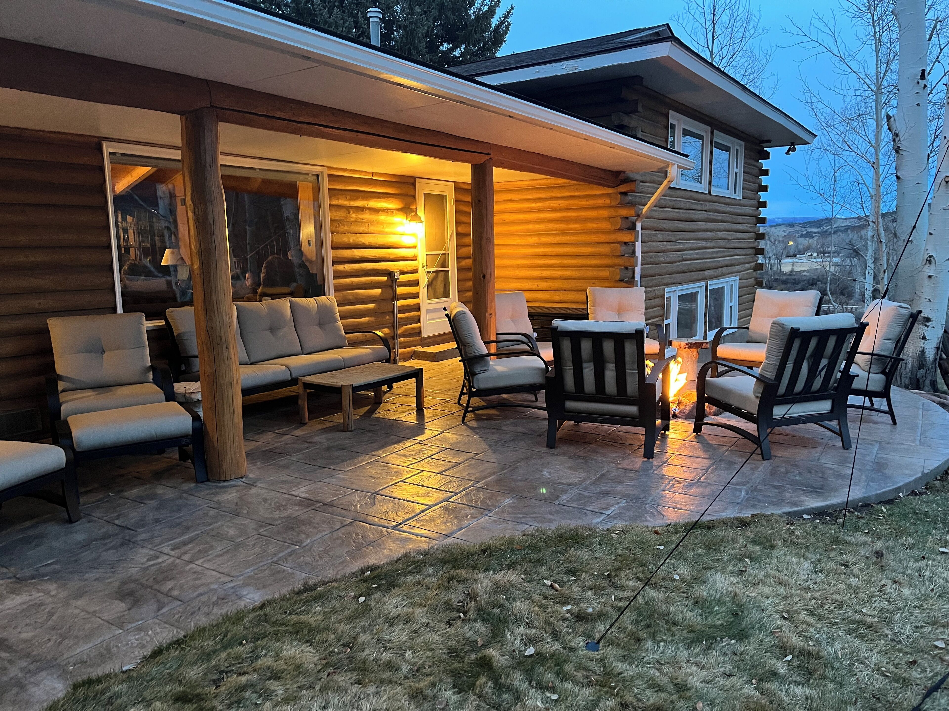 Beautiful front porch with large and comfortable seating and gas fire ring