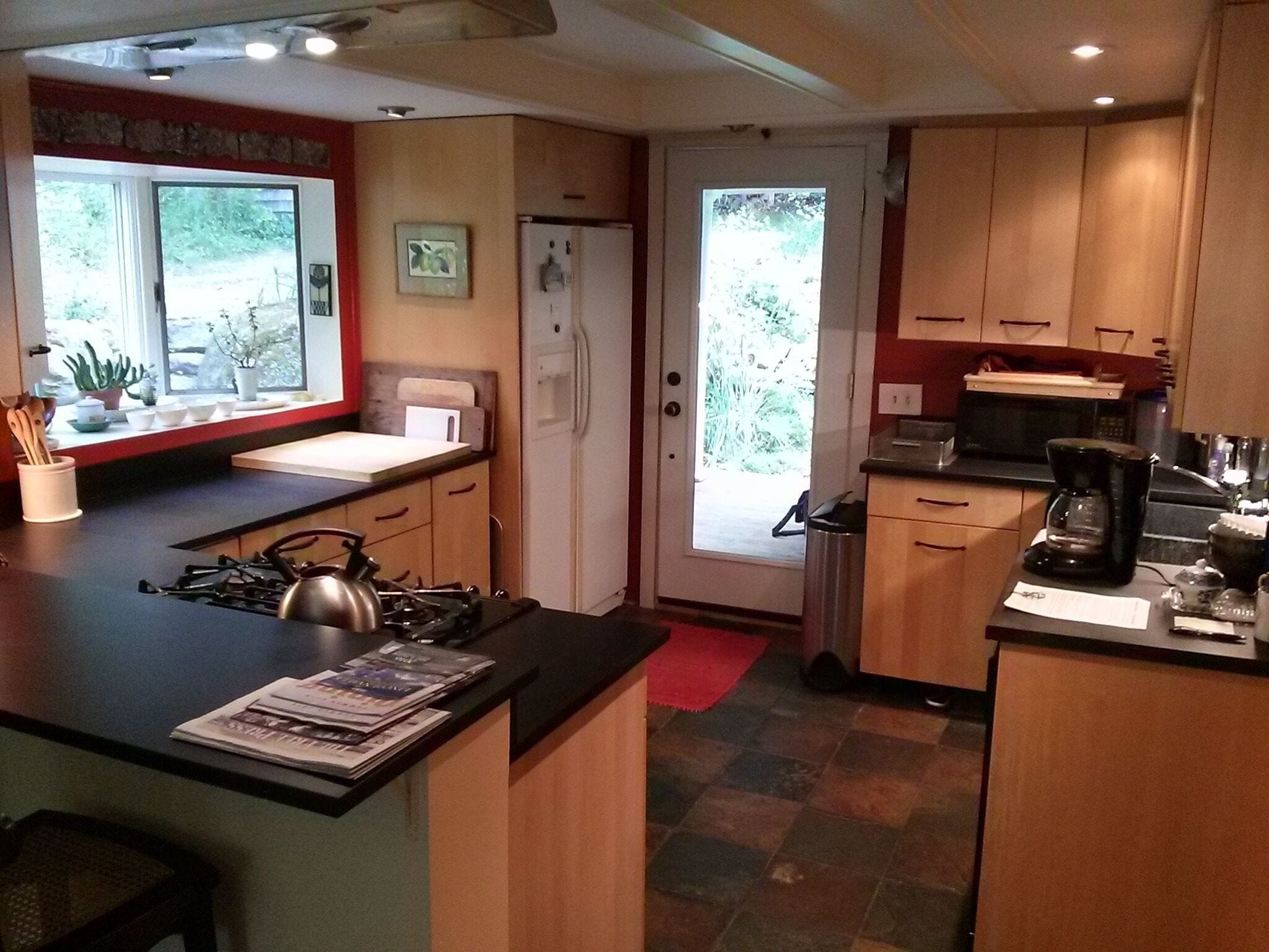 Kitchen features gas stove with electric convection oven, an old farmhouse sink.