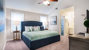A bedroom with a large bed, a ceiling fan, and a view to the bathroom. - Winter Discounts/We love pets! 6ft fenced in backyard and pet amenities. (Hanahan)