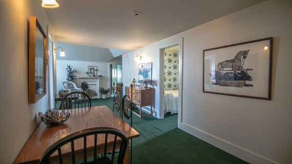 A dining area with a wooden table and chairs, a fireplace, and a Christmas tree. - Across the Street from Cooperstown Dreams Park (Milford)