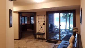 A spacious living area with a large sliding glass door leading to a patio.