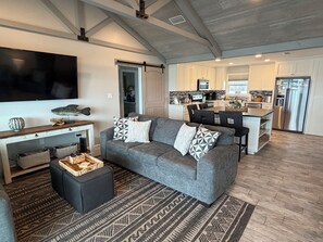 A modern living room with a grey sofa, patterned cushions, a flat-screen TV, and a wooden coffee table. - LOWER FALL RATES!
BEAUTIFUL BEACHFRONT PROPERTY!
BOOK YOUR RELAXING GETAWAY NOW! (Gulf Shores)