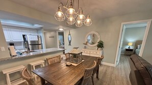 A modern kitchen with white cabinets, a granite countertop, and stainless steel appliances.
