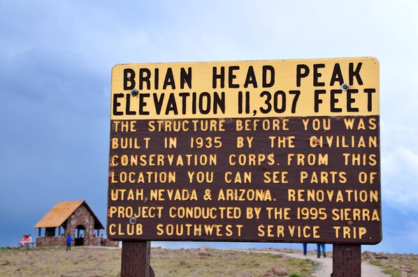 A sign with the text 'BRIAN HEAD PEAK ELEVATION 11,307 FEET' and additional historical information. - Ski, Hike, Fun - Great Location!! Perfect 2 Br/2 Ba Condo! (Brian Head)