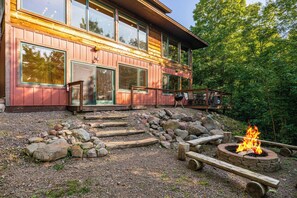 A wooden cabin with a fire pit and a deck. - Northern Comfort Overlooking Caribou Lake- Spacious and Secluded (Lutsen)