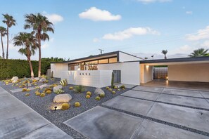 A modern house with a paved driveway, a cactus garden, and palm trees. - PS Chill: Meticulous Mid-Century Features Modern Comfort and Views! (Palm Springs)
