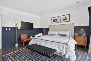 A modern hotel room with a large bed, a flat-screen TV, a desk, and a chair. - PS Chill: Meticulous Mid-Century Features Modern Comfort and Views! (Palm Springs)