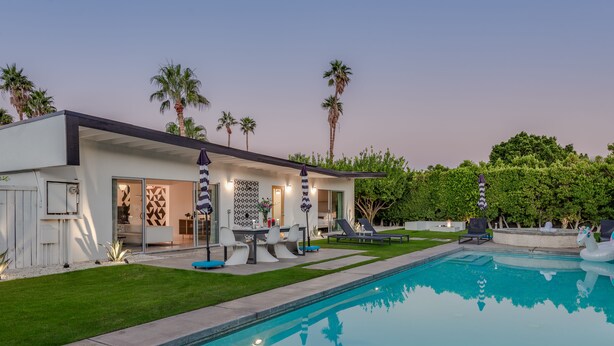 A modern house with a swimming pool, outdoor seating, and palm trees. - PS Chill: Meticulous Mid-Century Features Modern Comfort and Views! (Palm Springs)
