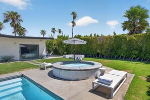 A backyard with a swimming pool, a hot tub, lounge chairs, and a modern house. - PS Chill: Meticulous Mid-Century Features Modern Comfort and Views! (Palm Springs)