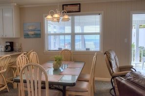 Enjoy meals in this inviting dining area with a glass table and comfortable chairs.