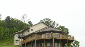 A two-story house with a balcony on the second floor.