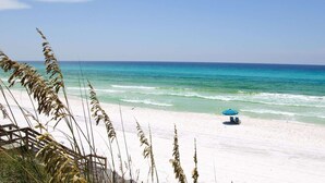A beach with a clear view of the ocean, a sandy shore, and a blue umbrella. - Tops`l Beach Manor 803 - Gorgeous Views! (Miramar Beach)