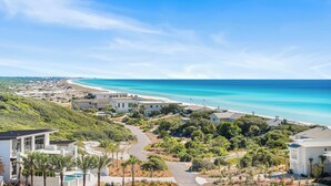 A coastal residential area with houses, a winding road, and a beach in the background. - Tops`l Beach Manor 803 - Gorgeous Views! (Miramar Beach)