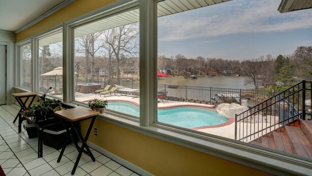 A balcony with a view of a swimming pool and a lake. - family vacation, BOATING, with heated pool Waterfront Lake wylie home -hot tub  (Charlotte)