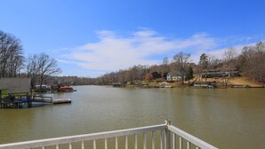 A calm river with docks and a small house on the right bank. - family vacation, BOATING, with heated pool Waterfront Lake wylie home -hot tub  (Charlotte)