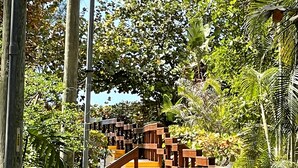 A wooden staircase leading up to a building, surrounded by lush greenery and palm trees. - Fantastic Island Getaway at Sunset Captiva 48 (Captiva)