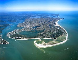 An aerial view of a coastal city with a dense urban area, a large bay, and a curved coastline. - 5-Min Walk to Beach! Private Heated Pool & 5BR Home (Marco Island)