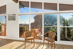 Relax in a serene space with expansive views of the surrounding landscape from large windows.
