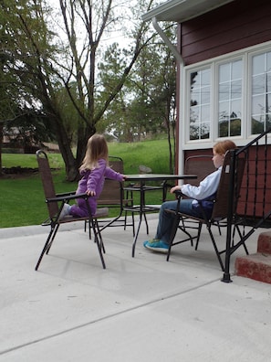 Relax in a serene outdoor space with two comfortable chairs and a small table.
